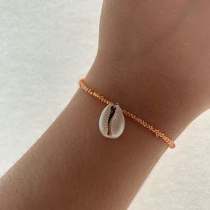 Homemade Peach beaded bracelet with shell charm.